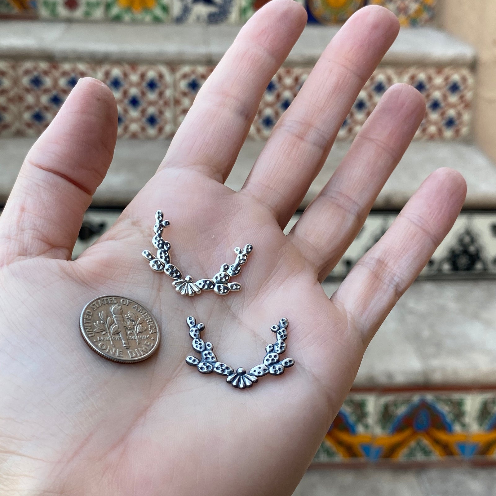 Silver prickly pear casting border larger with dime for size reference