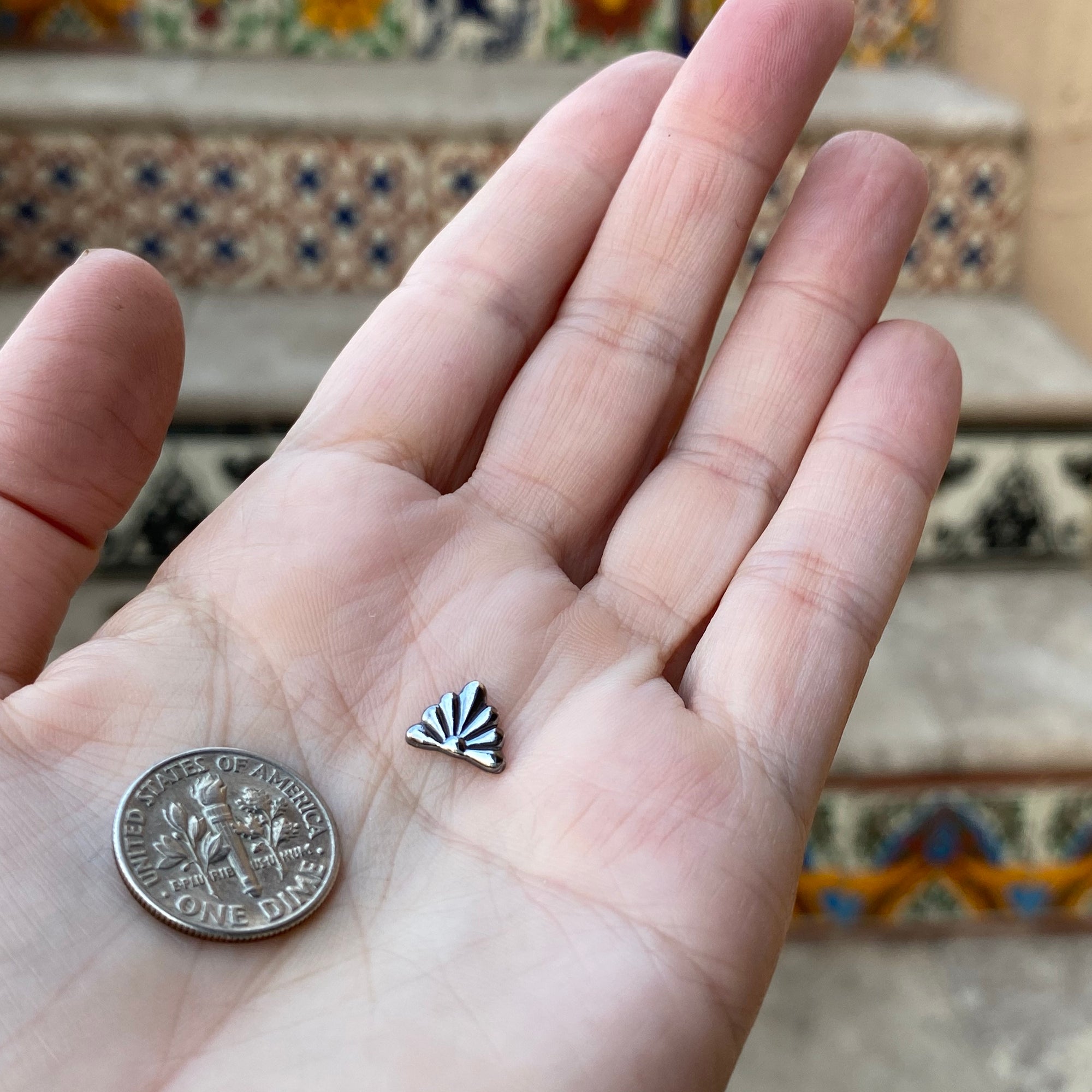 cast silver talavera tile smaller than a dime